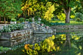 ABLINGTON MANOR  GLOUCESTERSHIRE: VIEW ACROSS THE RIVER COLN TO GAZEBO STEPS AND REFLECTIONS - CLASSIC COUNTRY GARDEN  ROMANCE  ROMANTIC  SUMMER  JUNE