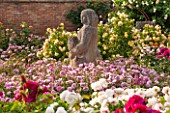 DAVID AUSTIN ROSES, ALBRIGHTON, WEST MIDLANDS: THE VICTORIAN WALLED GARDEN. SCULPTURE BY PAT AUSTIN WITH ROSE - ROSA HARLOW CARR. SCENT, SCENTED, BORDER, PROFUSION, FLOWERS, BED