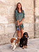 CIUTADELLA MENORCA, SPAIN: EVELYNE MANDEL HOUSE - EVELYN MANDEL OUTSIDE HER HOUSE WITH HER TWO DOGS