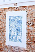 JONATHAN BAILLIE GARDEN, ALAIOR, MENORCA: ABSTRACT PAINTING ON HOUSE WALL IN BLUE AND WHITE