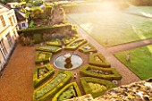 LAMPORT HALL, NORTHAMPTONSHIRE: AERIAL VIEW LOOKING DOWN ONTO THE ITALIAN GARDEN WITH BOX PARTERRES, GRAVEL PATHS AND FOUNTAIN. FORMAL, HISTORIC, CLASSIC ENGLISH GARDEN