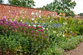 LAMPORT HALL, NORTHAMPTONSHIRE: BORDER IN THE WALLED KITCHEN GARDEN - CUTTING GARDEN WITH AGAPANTHUS, JOE PYE WEED - EUPATORIUM AND HOLLYHOCKS - FLOWERS, AUGUST, SUMMER