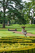 LAMPORT HALL, NORTHAMPTONSHIRE: VIEW OVER THE ITALIAN PARTERRE GARDEN TO URNS AND CEDAR TREE BEYOND. LAWN, FORMAL, CLASSIC ENGLISH, COUNTRY GARDEN