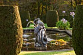 HOLE PARK, KENT: FORMAL ITALIAN POOL / POND GARDEN IN FRONT OF THE HOUSE WITH FOUNTAINS, AGAPANTHUS HOLE PARK BLUE AND CLIPPED TOPIARY SHAPES - EARLY MORNING, DAWN, AUTUMN, OCTOBER