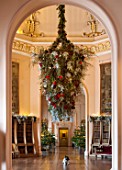 CASTLE HOWARD, YORKSHIRE: CHRISTMAS - DEE THE DOG SITS BENEATH AN ENORMOUS HANGING DECORATION IN THE OCTAGON - DECORATIVE, ORNAMENT, WINTER, BAUBLES, FESTIVE, ANIMAL, PET