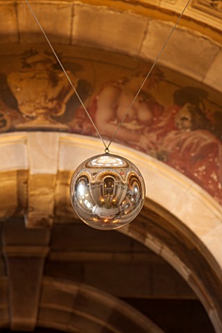 CASTLE_HOWARD_YORKSHIRE_CHRISTMAS__THE_GREAT_HALL_DECORATED_FOR_CHRISTMAS__LARGE_BAUBLE_HANGING_FROM