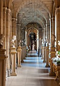 CASTLE HOWARD, YORKSHIRE: CHRISTMAS - THE ANTIQUE PASSAGE DECORATED AT CHRISTMAS WITH WHITE ORCHIDS - DECORATIVE, ORNAMENT, FESTIVE, WINTER, NOVEMBER