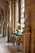 CASTLE HOWARD, YORKSHIRE: CHRISTMAS - THE ANTIQUE PASSAGE DECORATED AT CHRISTMAS WITH WHITE ORCHIDS, CANDLES AND WREATHS - DECORATIVE, ORNAMENT, FESTIVE, WINTER, NOVEMBER