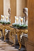 CASTLE HOWARD, YORKSHIRE: CHRISTMAS - THE ANTIQUE PASSAGE DECORATED AT CHRISTMAS WITH WHITE ORCHIDS, CANDLES AND WREATHS - DECORATIVE, ORNAMENT, FESTIVE, WINTER, NOVEMBER