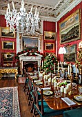 CASTLE HOWARD, YORKSHIRE: CHRISTMAS - THE CRIMSON DINING ROOM DECORATED FOR CHRISTMAS WITH CANDLES - DECORATIVE, ORNAMENT, WINTER, NOVEMBER, FIREPLACE, RED DAMASK