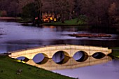 PAINSHILL PARK, SURREY: THE FIVE ARCH BRIDGE AND CRYSTAL GROTTO LIT UP AT NIGHT - LIGHTING, FOLLY, FOLLIES, HISTORIC, LAKE, WATER, LANDSCAPE, WINTER, DECEMBER, CHRISTMAS