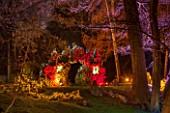 PAINSHILL PARK, SURREY:  PART OF THE CRYSTAL GROTTO  LIT UP AT NIGHT - LIGHTING, FOLLY, FOLLIES, HISTORIC, LAKE, WATER, LANDSCAPE, WINTER, DECEMBER, CHRISTMAS