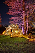 PAINSHILL PARK, SURREY: PART OF THE CRYSTAL GROTTO  LIT UP AT NIGHT - LIGHTING, FOLLY, FOLLIES, HISTORIC, LAKE, WATER, LANDSCAPE, WINTER, DECEMBER, CHRISTMAS, TREE, TREES