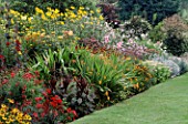 COLOURFUL HERBACEOUS BORDERS AT THE PRIORY  KEMERTON  HEREFORD & WORCESTER WITH HELENIUMS  DAHLIAS & CROCOSMIA