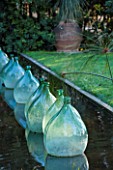 CLOS DU PEYRONNET, MENTON, FRANCE: POOL / POND WITH GLASS BOTTLES / JARS IN WATER. ORNAMENT, FEBRUARY, MEDITERRANEAN. CANAL, RILL