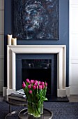SALLY STOREY HOUSE, LONDON: OPEN PLAN SITTING ROOM / HALL WITH FIREPLACE, PAINTING BY SALLYS DAUGHTER LUCCA, CHIMNEY PAINTED IN FARROW & BALL DOWNPIPE