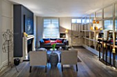 SALLY STOREY HOUSE, LONDON: OPEN PLAN SITTING ROOM / HALL WITH FIREPLACE, PAINTING, MIRRORED WALL, MIRROR, SETTEE, CHAIRS, RUG, LIGHT, CHIMNEY PAINTED IN FARROW & BALL DOWNPIPE