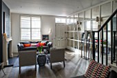 SALLY STOREY HOUSE, LONDON: OPEN PLAN SITTING ROOM / HALL WITH FIREPLACE, PAINTING, MIRRORED WALL, MIRROR, SETTEE, CHAIRS, RUG, LIGHT, CHIMNEY PAINTED IN FARROW & BALL DOWNPIPE