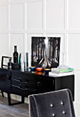 SALLY STOREY HOUSE, LONDON: OPEN PLAN SITTING ROOM / HALL WITH GREY CHAIR AND BLACK SIDEBOARD WITH PAINTING