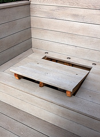 SALLY_STOREY_HOUSE_LONDON_ROOF_TERRACE_WITH_FAKE_WOODEN_DECKING_AND_LID_OF_STORAGE_AREA_WITH_HOLES_F