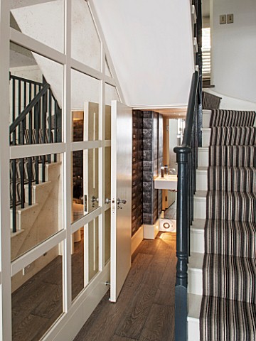 SALLY_STOREY_HOUSE_LONDON_STAIRCASE_IN_LIVING_ROOM_WITH_MIRRORED_WALLS_AND_DOWNSTAIRS_TOILET_LOO_REF