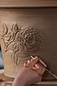 WHICHFORD POTTERY, WARWICKSHIRE: SAS COOPER FETTLING THE TUDOR ROSE DESIGN ON QUEENS 90TH BIRTHDAY TERRACOTTA CONTAINER IN WORKSHOP