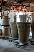 WHICHFORD POTTERY, WARWICKSHIRE: LARGE NEWLY THROWN BESPOKE 3 PIECE ACANTHUS TERRACOTTA CONTAINERS DRYING OUT IN THE WORKSHOP