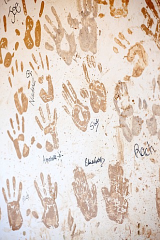 WHICHFORD_POTTERY_WARWICKSHIRE_HAND_PRINTS_OF_POTTERS_ON_THE_WALL_IN_THE_WORKSHOP