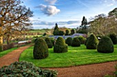 BROUGHTON GRANGE, OXFORDSHIRE: VIEW FROM THE LOWER PARTERRE OF THE WALLED GARDEN TO LAWN WITH CLIPPED TOPIARY YEWS - COUNTRYSIDE BEYOND - BORROWED L;ANDSCAPE, COUNTRY, GARDEN