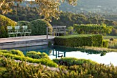 LA JEG, PROVENCE, FRANCE: DESIGNER ANTHONY PAUL - SWIMMING POOL AND DECK WITH CLIPPED TOPIARY. MAY, MEDITERRANEAN, WATER, GARDEN, FORMAL, POND, DECKING, DECKED