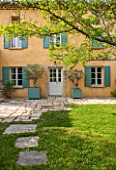 LA JEG, PROVENCE, FRANCE: DESIGNER ANTHONY PAUL - COURTYARD, HOUSE, LAWN, PAVING, STONE, PATH, VERSAILLES CONTAINER, SPRING, MEDITERRANEAN