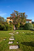 LA JEG, PROVENCE, FRANCE: DESIGN: ANTHONY PAUL - THE HOUSE WITH BLUE SHUTTERS. LAWN WITH PAVING STONE STEPS. SUMMER,  COUNTRY, GARDEN