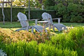 LA JEG, PROVENCE, FRANCE: DESIGNER ANTHONY PAUL -  TWO ADIRONDACK CHAIRS ON LAWN. WOOD, WOODEN, BENCH, CHAIR, A PLACE TO SIT, SPRING. MEDITERRANEAN, GARDEN, GREEN, PROVENCE, MAY