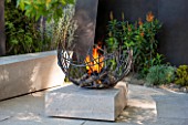 CHELSEA FLOWER SHOW 2016: TELEGRAPH GAREDEN DESIGNED BY ANDY STURGEON - LIMESTONE PATIO, BRONZE FINS AND METAL FIREPIT - SEATING, BENCH, BENCHES, FIRE