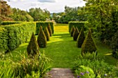 BRYANS GROUND, HEREFORDSHIRE: THE DIOVECOTE GARDEN - EIGHT CLIPPED YEW TOPIARY OBELISKS, HA HA AND VIEW OUT TO COUNTRYSIDE - ENGLISH GARDEN, SUMMER, GREEN, FOLIAGE