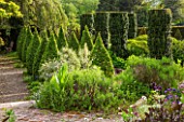 BRYANS GROUND, HEREFORDSHIRE: THE SUNK GARDEN - ARTS AND CRAFTS - CLIPPED BOX TOPIARY AND IRISH YEWS, ELEAGNUS ANGUSTIFOLIA QUICKSILVER. FORMAL, COUNTRY GARDEN