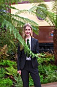 HOPE SHARP STORY, CHELSEA FLOWER SHOW 2016: HOPE SHARP BESIDE A FERN IN THE BOWDENS STAND - BEHIND IS ZENA - SISTER TRAIN TO THE ORIENT EXPRESS