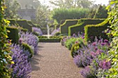 ARUNDEL CASTLE GARDENS, WEST SUSSEX: GRAVEL PATH, YEW HEDGES, NEPETA SIX HILLS GIANT AND ALLIUMS - BULB, BULBS, FLOWERS, ENGLISH GARDEN, FOUNTAIN, BORDER, BORDERS, HEDGE, HEDGING