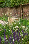 PRIVATE GARDEN LONDON DESIGNED BY LUCY WILLCOX AND ANA SANCHEZ MARTIN: FORMAL TOWN GARDEN WITH BRICK WALL, STONE SEAT / BENCH, PLEACHED HORNBEAM, ALLIUM MOUNT EVEREST