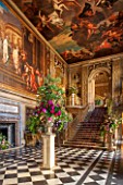 CHATSWORTH HOUSE, DERBYSHIRE: FLORABUNDANCE-THE PAINTED HALL DECORATED 1687-1694 BY LOUIS LAGUERRE BEAUTIFUL FLORAL DISPLAY ON STONE PLINTH. INTERIOR, OPULENCE, GRAND, STAIRCASE