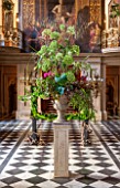 CHATSWORTH HOUSE, DERBYSHIRE: FLORABUNDANCE - THE PAINTED HALL WITH TOWERING FLORAL DISPLAY OF PEONIES AND ANGELICA ON STONE PLINTH. INTERIOR, GRAND, OPULENT.