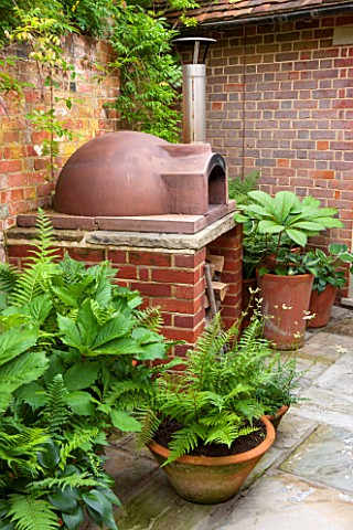 THE_COACH_HOUSE_SURREY_BBQBRICK_BARBEQUECHIMINEAOUTDOOR_COOKING_AREA_WITH_VARIOUS_FERMS_AND_RODGERSI