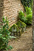 THE LODGE, BURFORD, OXFORDSHIRE: OLD VICTORIAN CLOCHES WITH FERNS BY HOUSE WALL. DETAIL.ANTIQUE, GARDEN.