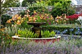 BELMONT HOUSE, SUSSEX - DESIGN ANTHONY PAUL: WALLED GARDEN, WATER FEATURE, FOUNTAIN, AGAPANTHUS, LILIES, COSMOS, MONARDA