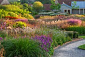 HAUSER & WIRTH, SOMERSET: THE OUDOLF FIELD, DURSLADE FARM - SUNSET - VIEW TO THE GALLERY - PLANTING BY PIET OUDOLF - PERENNIAL MEADOW, PATHS, NEW