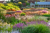 HAUSER & WIRTH, SOMERSET: THE OUDOLF FIELD, DURSLADE FARM - SUNSET - VIEW TO THE GALLERY - PLANTING BY PIET OUDOLF - PERENNIAL MEADOW, PATHS, NEW