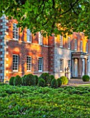 MORTON HALL GARDENS, WORCESTERSHIRE: THE FRONT OF THE HALL - BOX TOPIARY SHAPES - DAWN LIGHT, MORNING, ENGLISH, GARDEN, CLASSIC, TOPIARY, SUMMER, CHESTNUT TREE, GREEN