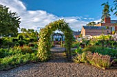 MORTON HALL GARDENS, WORCESTERSHIRE: KITCHEN GARDEN IN LATE SUMMER. GREENHOUSE, COUNTRY, HOUSE, CLASSIC, VEGETABLE, ARCH, ARCHWAY, SKY, CLEMATIS