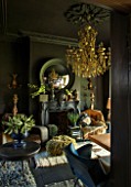 ABIGAIL AHERN HOUSE, LONDON: THE OFFICE / STUDIO. FIREPLACE, CONVEX MIRROR, ROOM PAINTED IN HUDSON BLACK PAINT, LAZZARO CHANDELIER