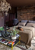 ABIGAIL AHERN HOUSE, LONDON: BEDROOM PAINTED IN CROSBY - MAUD THE DOG ON BED, PILLOWS, HAGUE WOODEN BEADED CHANDELIER, DARK, ROOM, INTERIOR, STAGHORN PLANT, THROW